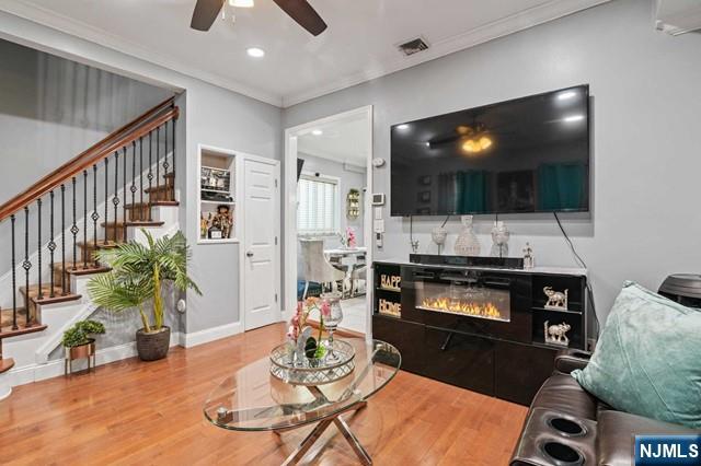 7 Martin Street Paterson, NJ 07501 - Photo 3 of 18 a living room with furniture and a flat screen tv
