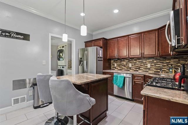 7 Martin Street Paterson, NJ 07501 - Photo 5 of 18 a kitchen with stainless steel appliances granite countertop a stove refrigerator sink and cabinets
