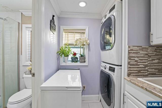 7 Martin Street Paterson, NJ 07501 - Photo 7 of 18 a bathroom with a sink a washer and dryer next to a window