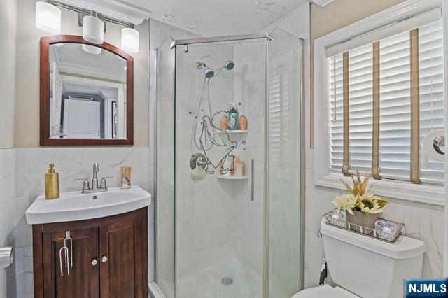 7 Martin Street Paterson, NJ 07501 - Photo 8 of 18 a bathroom with a sink a toilet and shower curtain
