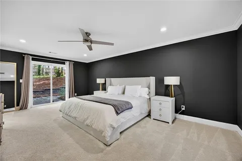 a large bed sitting in a room next to a window