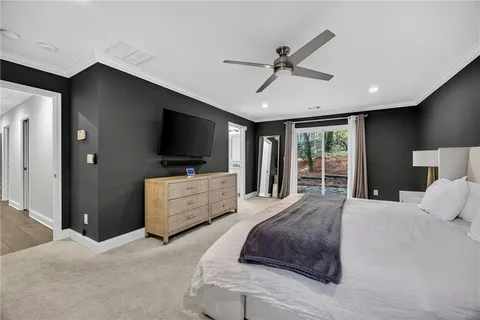 a bedroom with a large bed and a flat screen tv