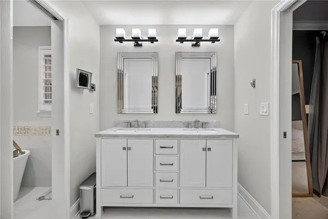 a bathroom with double sink and mirror