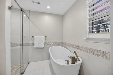 a bathroom with a bathtub and shower