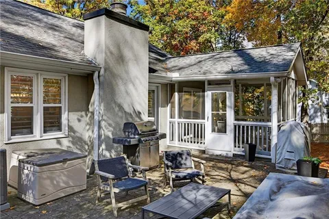a view of house with a chairs and table in a patio