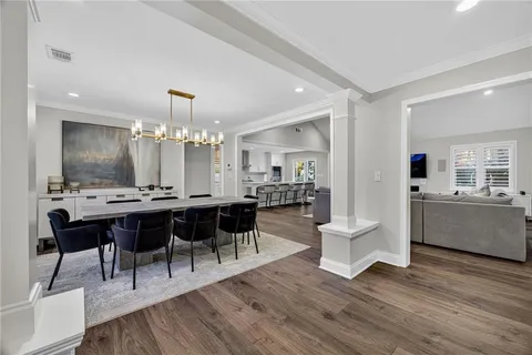 a view of a dining room with furniture and wooden floor