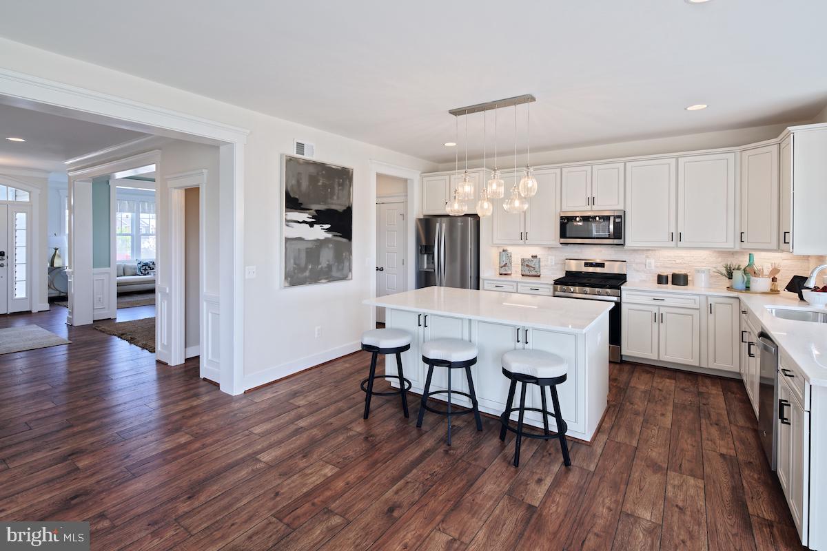 111 Interlace Way Stephenson, VA 22656 - Photo 4 of 27 a kitchen with a sink cabinets and wooden floor