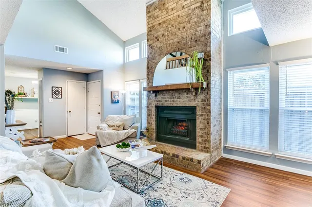 a living room with furniture a rug and a fireplace