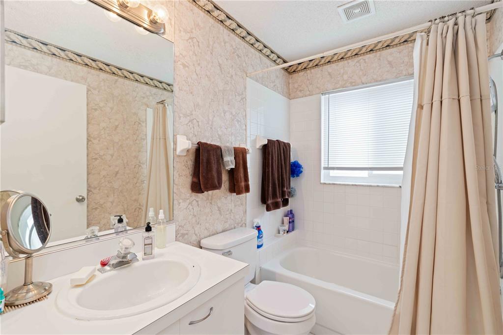 4513 Dover St Circle East Bradenton, FL 34203 - Photo 16 of 30 a bathroom with a sink toilet and shower