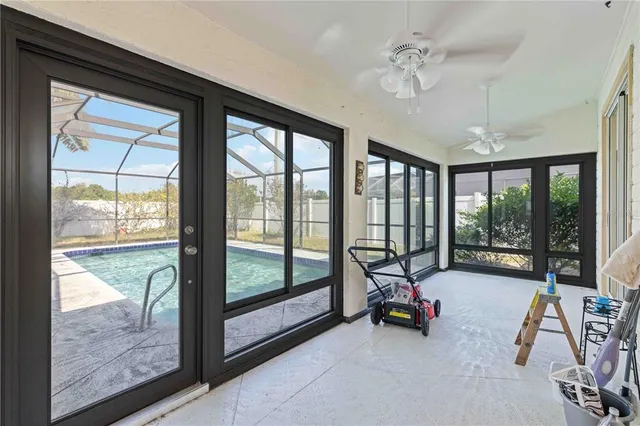 a view of a room with gym equipment and large windows