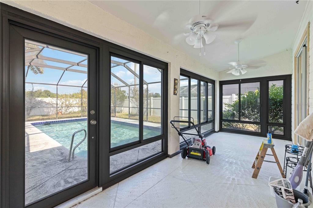 4513 Dover St Circle East Bradenton, FL 34203 - Photo 25 of 30 a view of a room with gym equipment and large windows