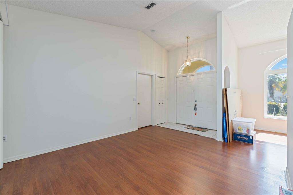 4513 Dover St Circle East Bradenton, FL 34203 - Photo 7 of 30 a view of empty room with wooden floor and fan