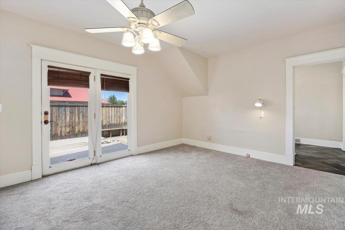 813 7th Street Rupert, ID 83350 - Photo 27 of 48 Light gray carpeted room with a ceiling fan, dual French doors, a built-in wall sconce, and white trim