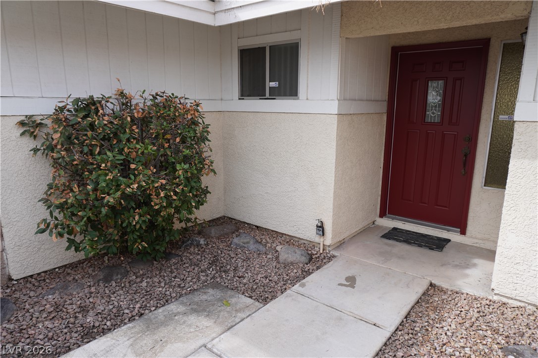 8328 Del Rey Avenue Las Vegas, NV 89117 - Photo 3 of 38 A welcoming entry, with a bold red door and xeriscape landscaping for minimal upkeep.