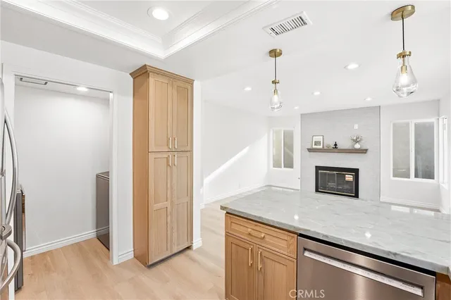 a kitchen with a refrigerator and white cabinets