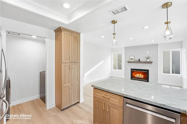 a view of a kitchen with a sink and a refrigerator