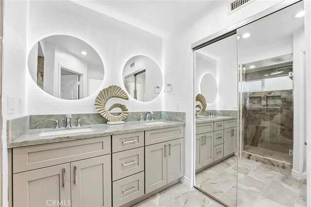 a bathroom with double sink and a mirror