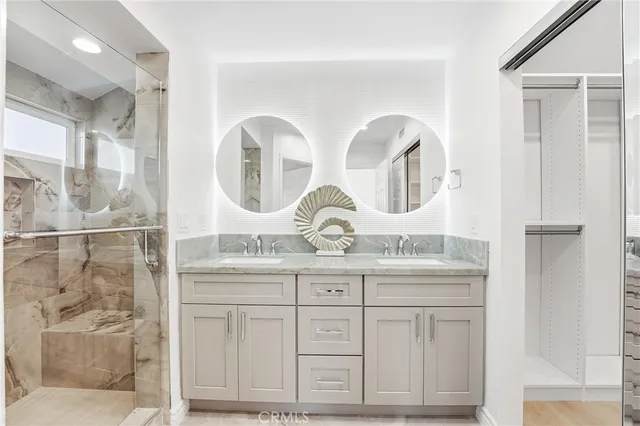 a bathroom with a double vanity sink and a mirror