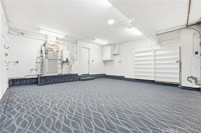 an empty room with wooden floor and white walls