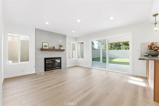 a view of an empty room with a fireplace and a window