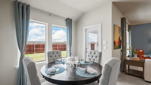 a kitchen with sink a microwave and cabinets