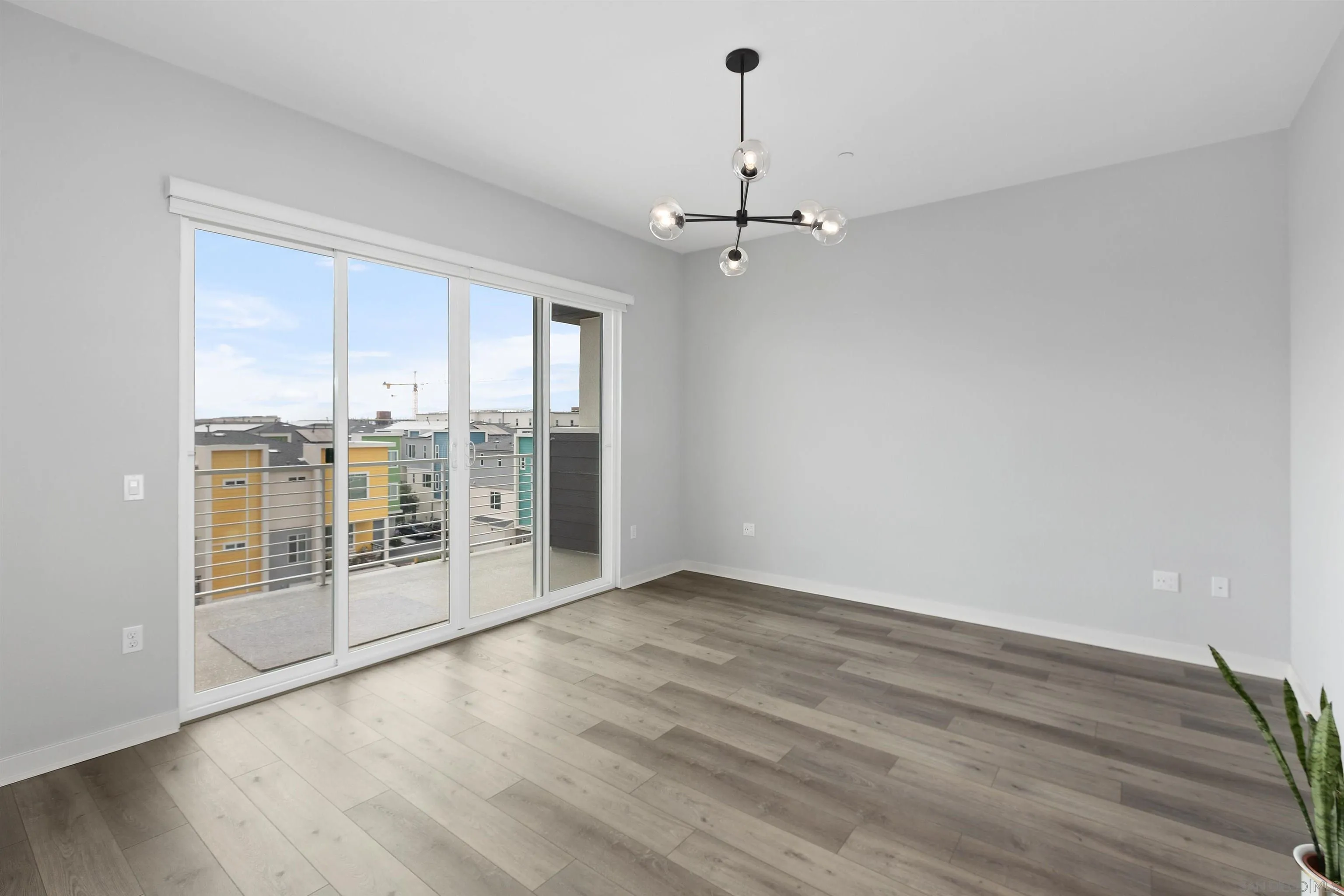 3002 Bravo Loop, Unit 4 Chula Vista, CA 91915 - Photo 16 of 36 an empty room with wooden floor and windows