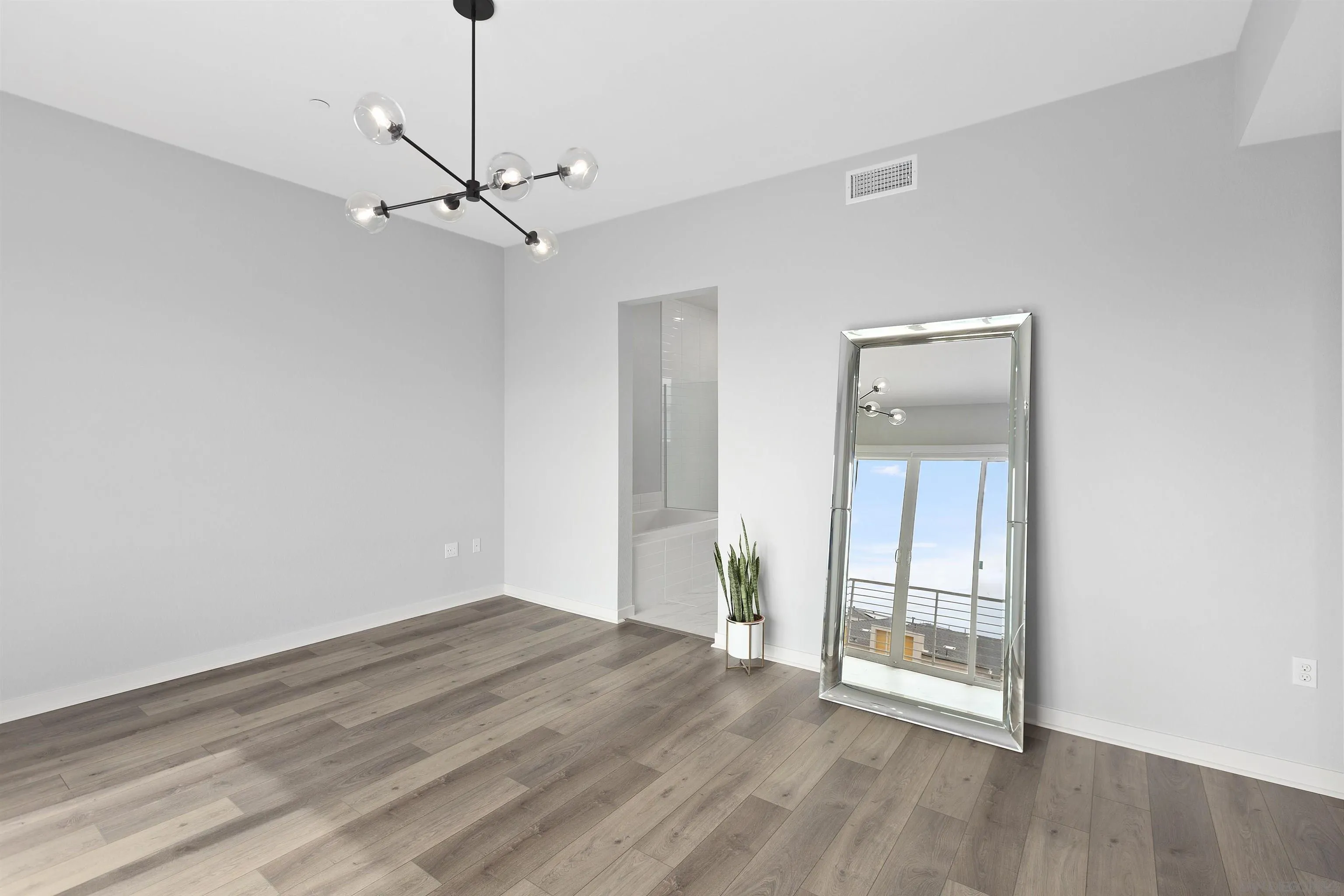 3002 Bravo Loop, Unit 4 Chula Vista, CA 91915 - Photo 25 of 36 a view of an empty room with wooden floor and a window