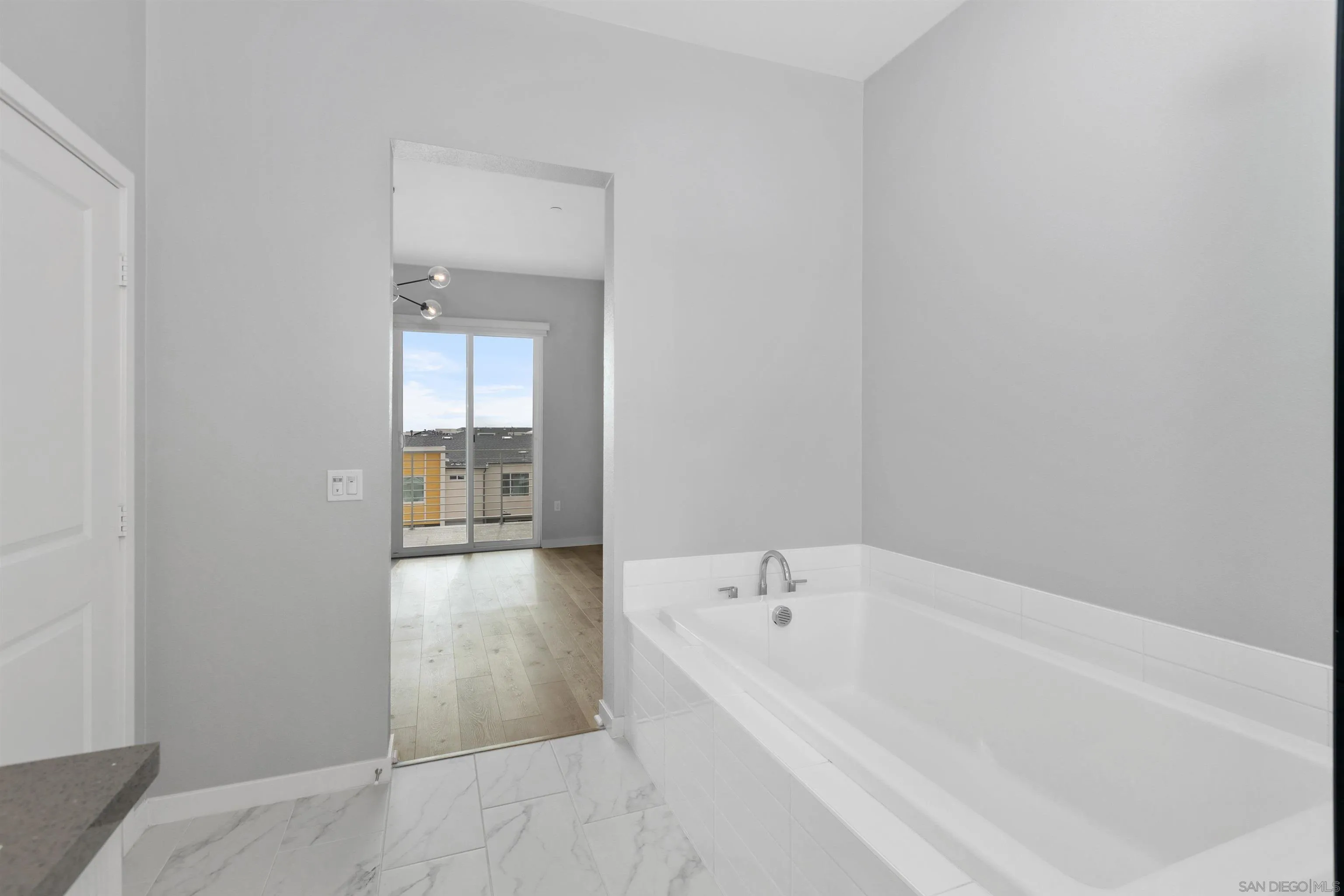 3002 Bravo Loop, Unit 4 Chula Vista, CA 91915 - Photo 32 of 36 a bathroom with a bathtub and mirror