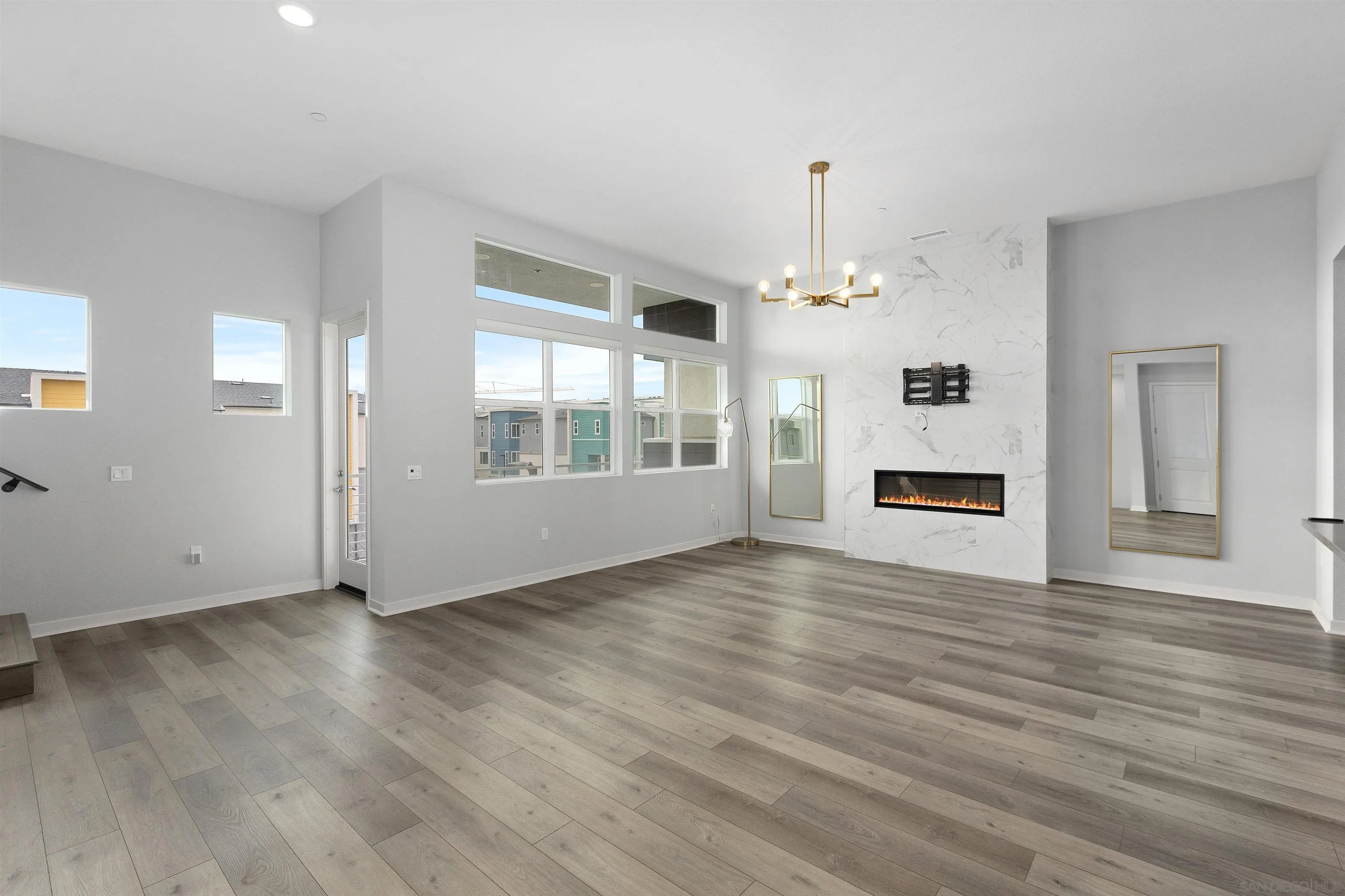 3002 Bravo Loop, Unit 4 Chula Vista, CA 91915 - Photo 7 of 36 a view of empty room with wooden floor and window