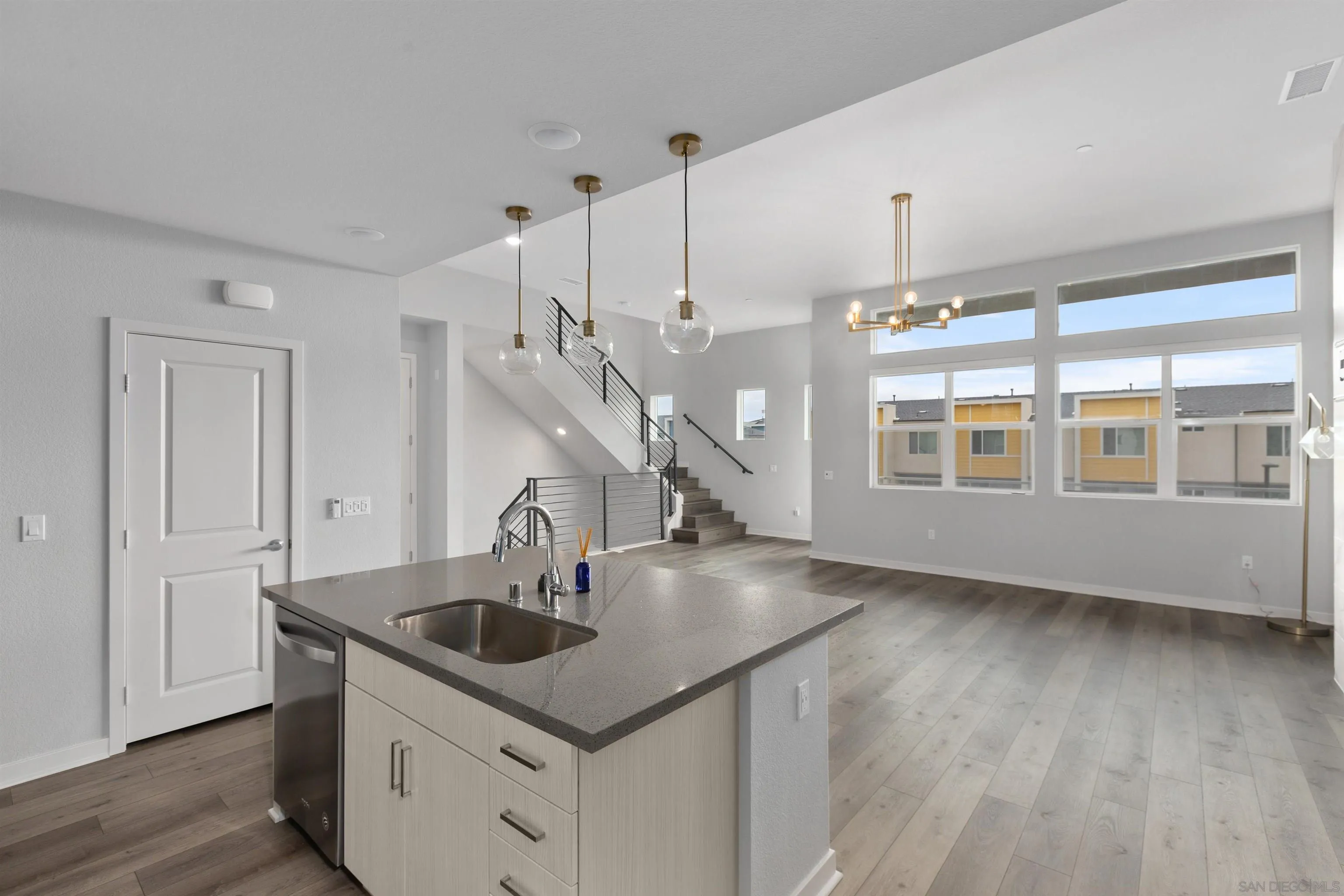 3002 Bravo Loop, Unit 4 Chula Vista, CA 91915 - Photo 8 of 36 a kitchen with stainless steel appliances granite countertop a sink a stove and a large window