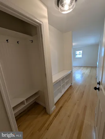 a view of a room with wooden floor