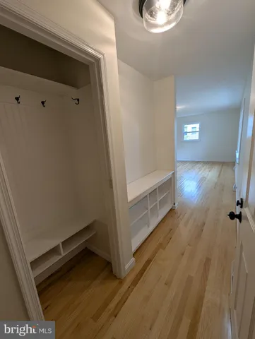 a view of a room with wooden floor