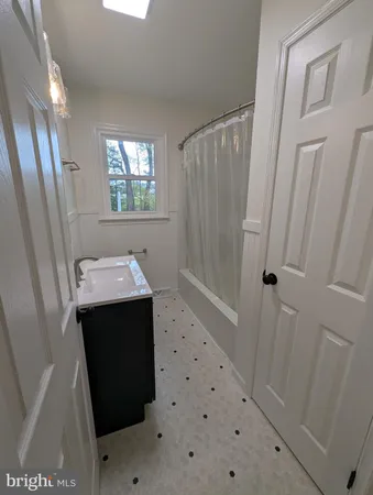 a bathroom with a sink a mirror and a shower