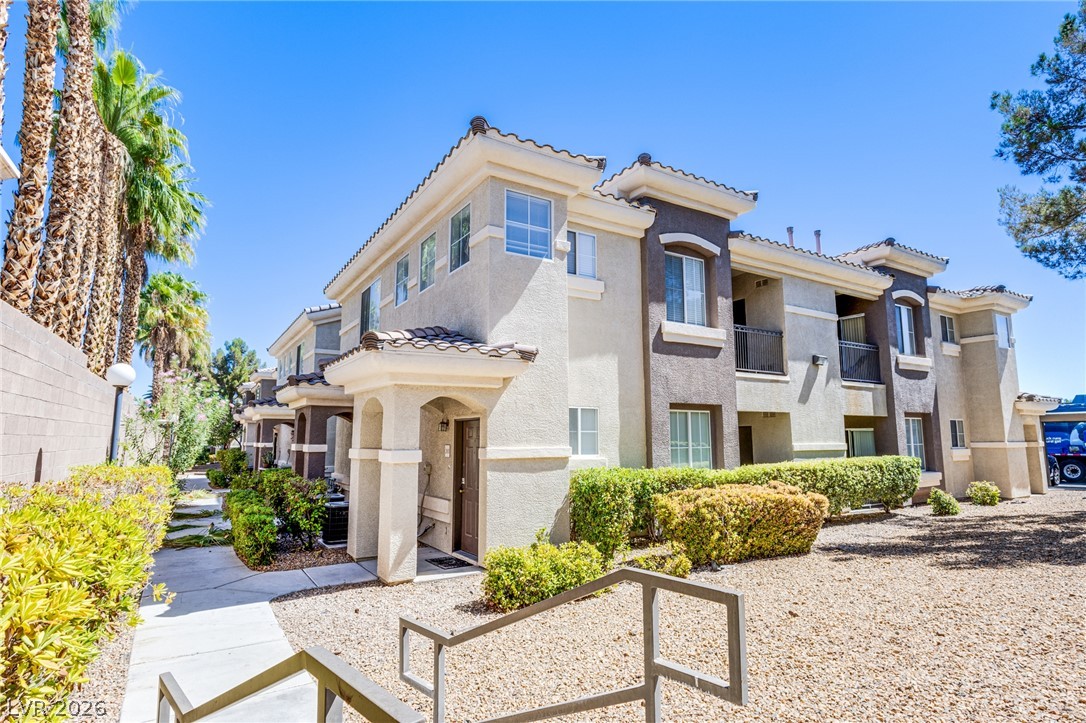 9050 West Warm Springs Road, Unit 1011 Las Vegas, NV 89148 - Photo 18 of 32 Mediterranean-inspired multi-family complex featuring well-maintained landscaping and private entrances.