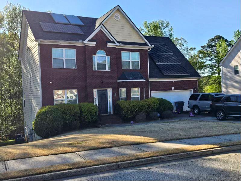 a front view of a house with a yard