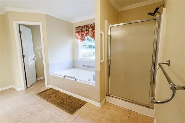 a bedroom with a bed window and a flat screen tv