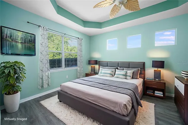 a bedroom with a large bed and a potted plant