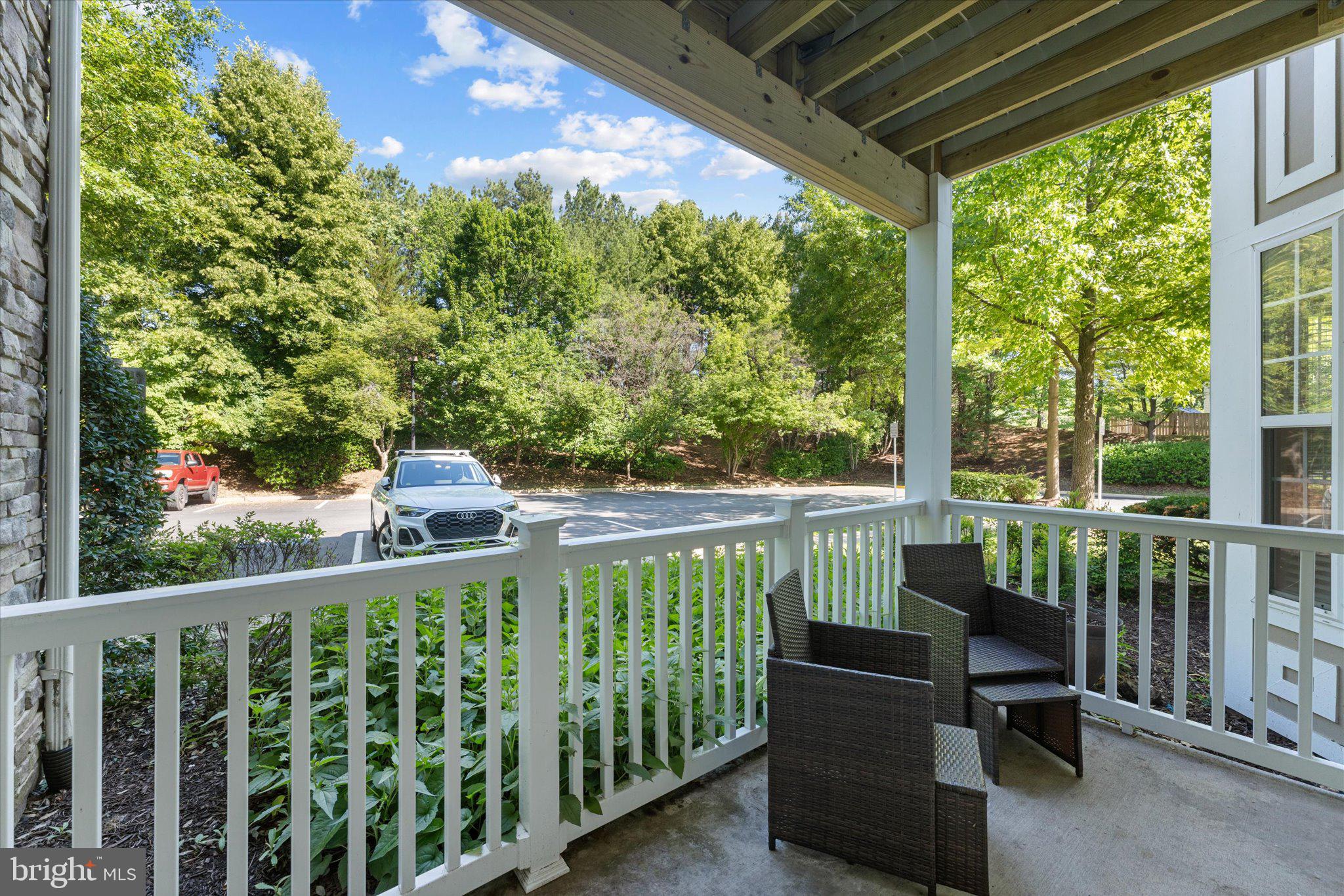 503 Sunset View Terrace Southeast, Unit 101 Leesburg, VA 20175 - Photo 28 of 39 Serene porch with lush greenery views.