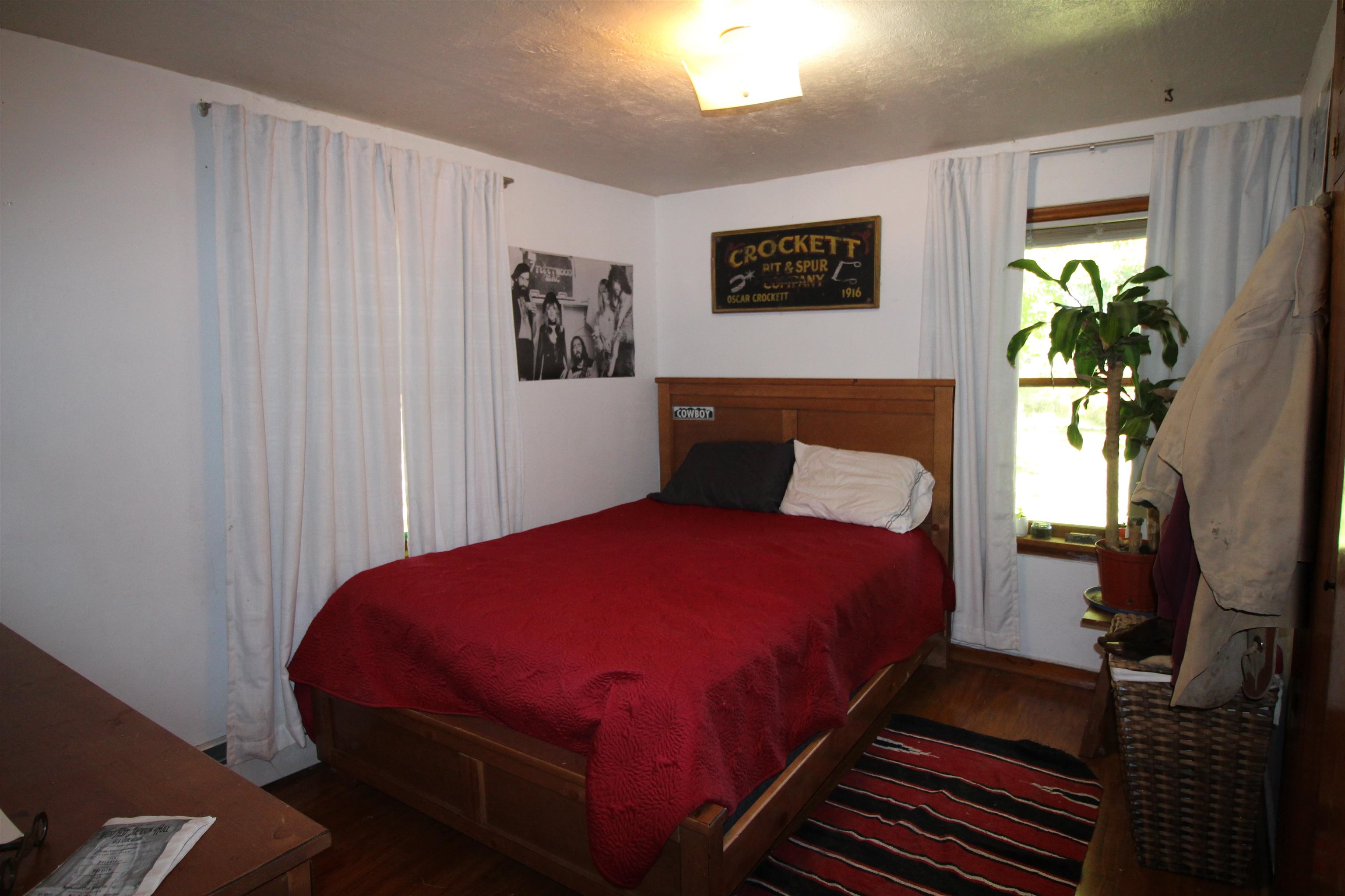 1873 K Road Fruita, CO 81521 - Photo 8 of 26 a bedroom with a bed and a potted plant
