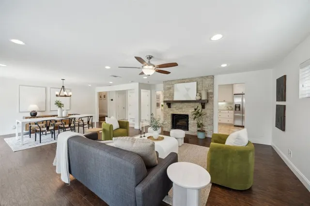 a living room with furniture fireplace and a table
