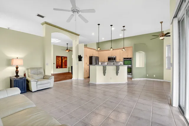 a kitchen with stainless steel appliances granite countertop a refrigerator and a stove top oven
