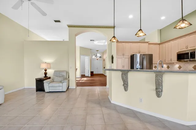 a dining room with furniture and a large window