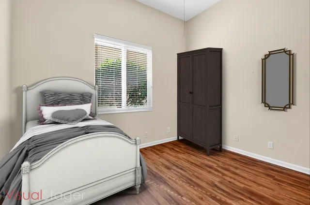 a front view of multi story residential apartment building with yard and green space