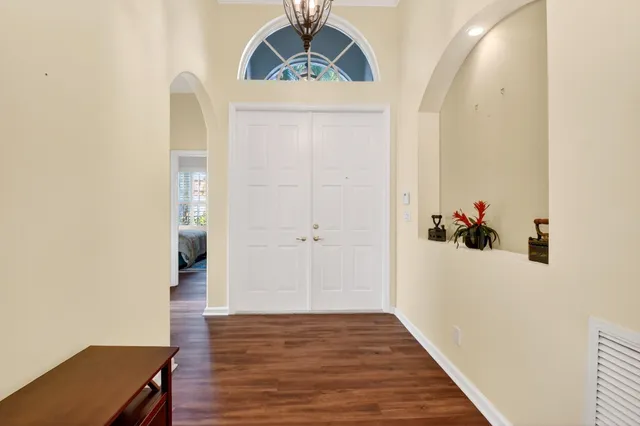 a view of a hallway with wooden floor and closet