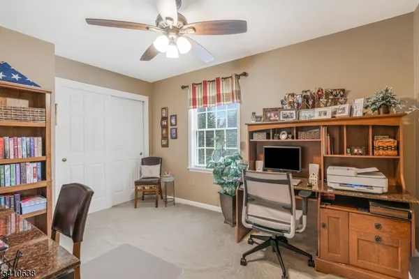 a living room with furniture a piano and a bookshelf