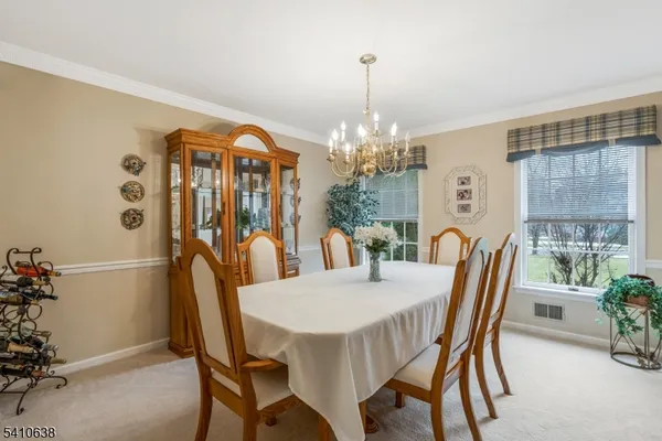 a view of a dining room with furniture window and chandelier