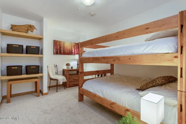 a view of swimming pool with lawn chairs and plants