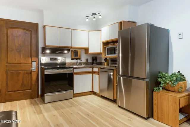 an aerial view of multiple houses with yard