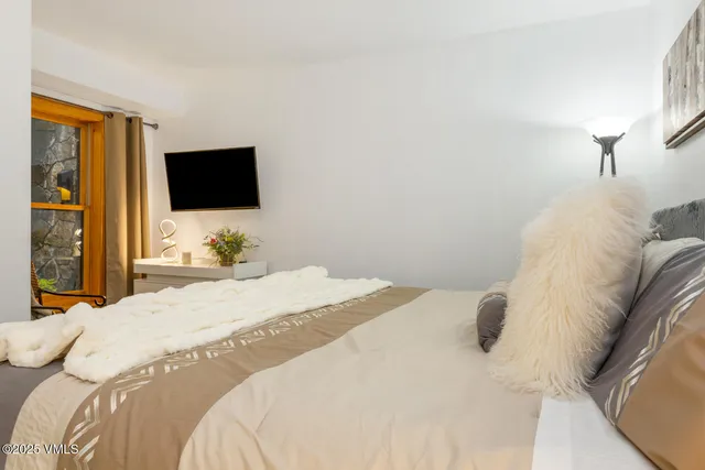 a living room with furniture large window and a fireplace