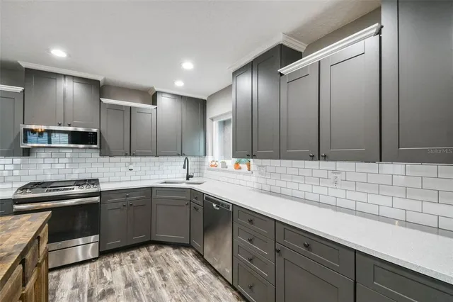 a kitchen with a sink and cabinets